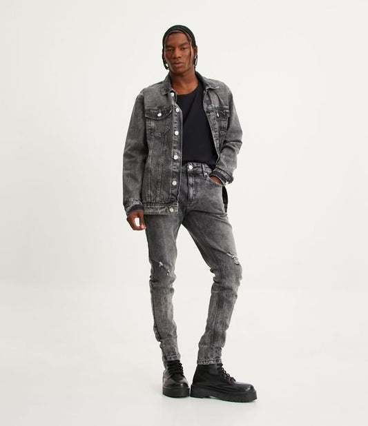Jeans super skinny con effetto distressed e marmorizzato nero