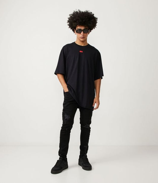 Jeans strappati super skinny neri con segni di distorsione