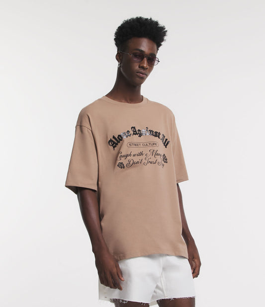 Camiseta Boxy de algodão com estampa "Against All" em marrom