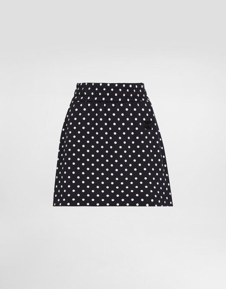 Minigonna in jersey con stampa a pois ed etichetta con logo