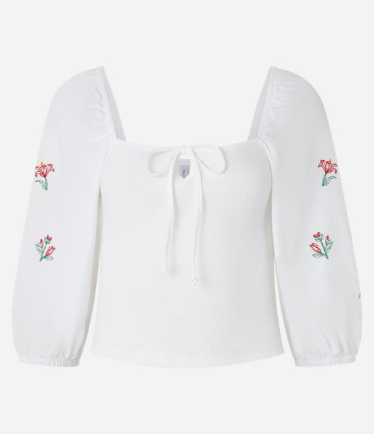 Blusa de canalé con lazo en el pecho y bordado floral blanco