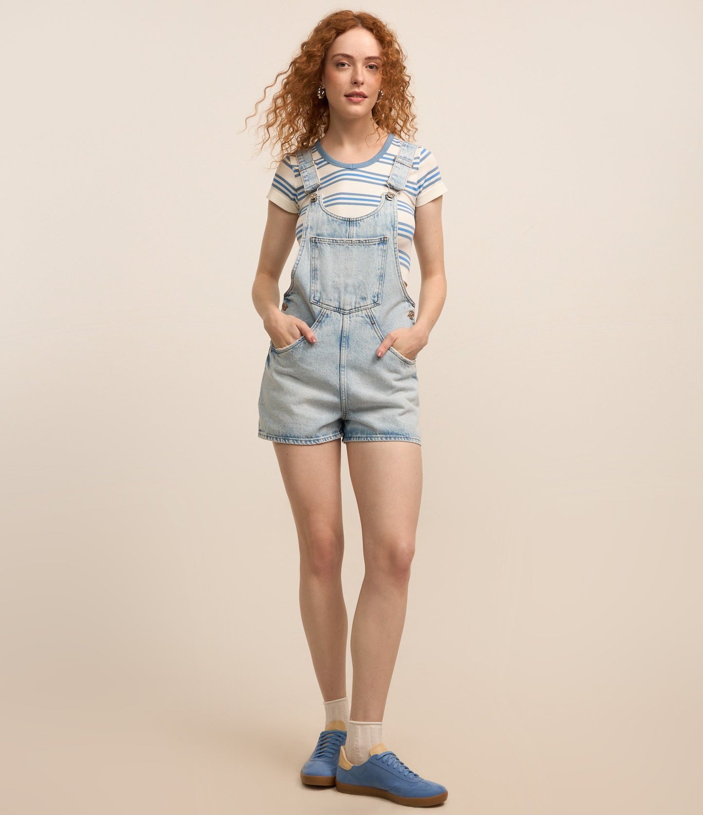Salopette corta in denim con lavaggio marmorizzato blu e tasca a canguro
