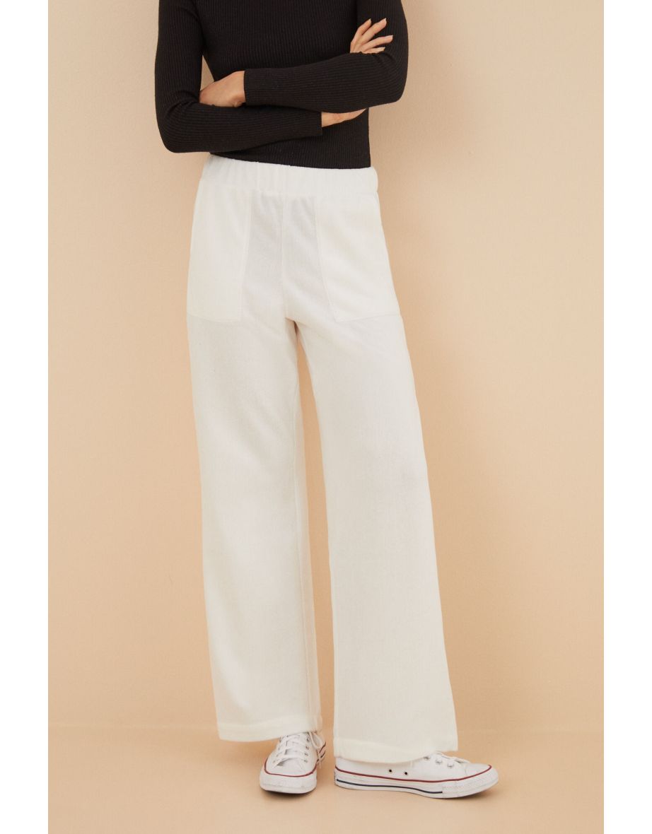 Pantaloni a gamba larga in velluto a coste avorio